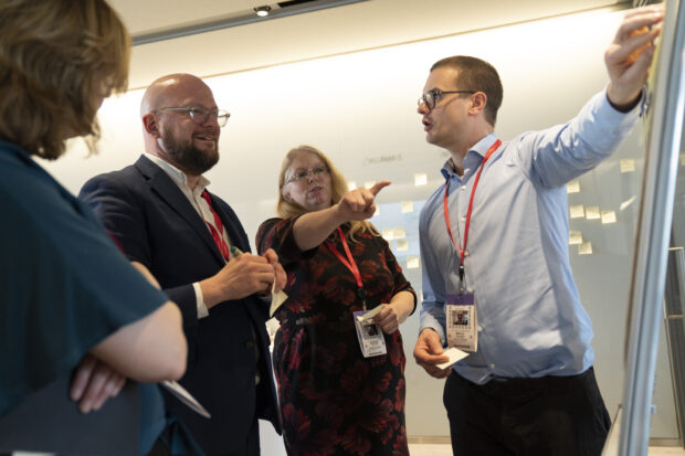 Sam Smith, Theo Blackwell, Sandra Taylor and Mikko Rusama stood around a flipchart, mapping out the challenges faced within their roles. Image courtesy of David Levenson.