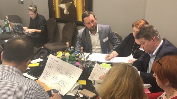 6 people in discussion around a table at the pilot of the Local Digital Leaders Accelerator training course. Image courtesy of @stamanfar on Twitter.