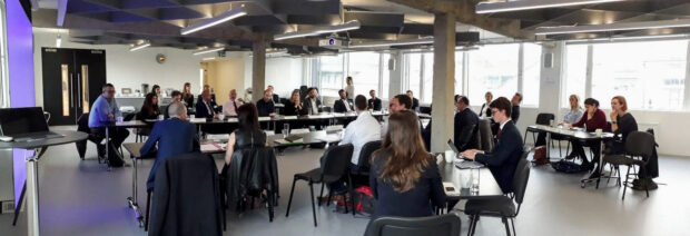 Wide angle photo of a room full of people watching a presentation screen. Taken from the Digital Land roundtable event hosted in November. Image courtesy of @psd on Twitter.