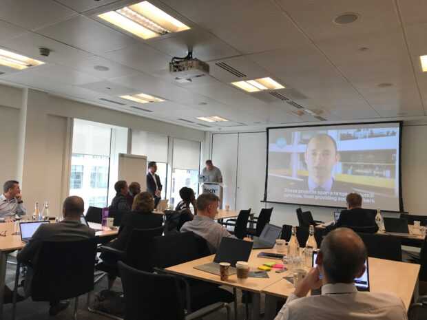 Project teams gathered at techUK's London office for the Local Digital Fund round 2 launch workshop. The image shows attendees of the workshop watching Paul Maltby, Chief Digital Officer at MHCLG, presenting to the room.