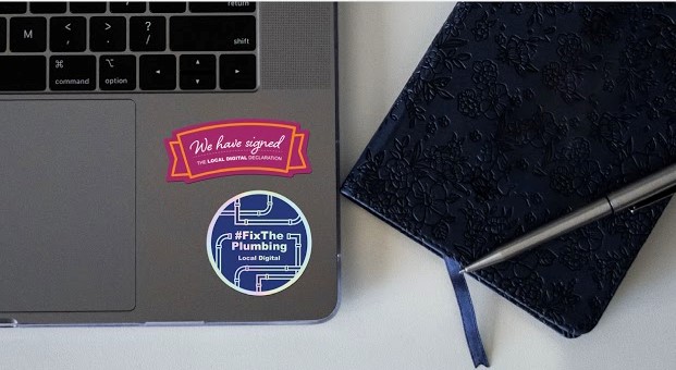 A photo of a laptop keypad with stickers