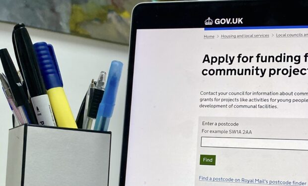 a laptop screen showing the 'apply for funding' page on gov.uk