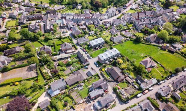 Aerial view of green space with businesses and housing