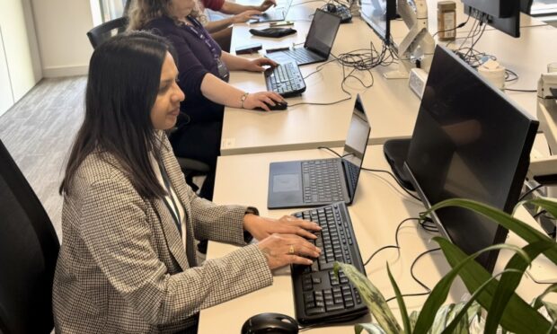 Poonam at her desk working 