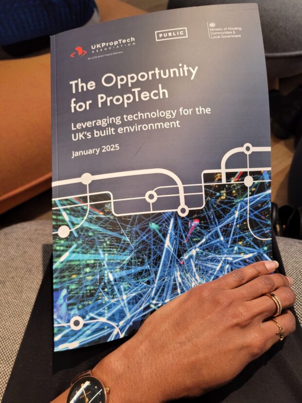 The front cover of the Opportunity for PropTech report, with a hand holding it.