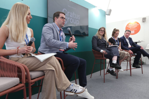 Milan Bogunovic, Digital Planning Programme Director with the microphone speaking at the UK’s Real Estate Investment and Infrastructure Forum 