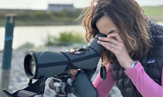 Jaimella Espley looking through a bird watching camera